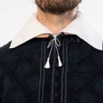 Collar and shoulders of a doublet on a bearded male model